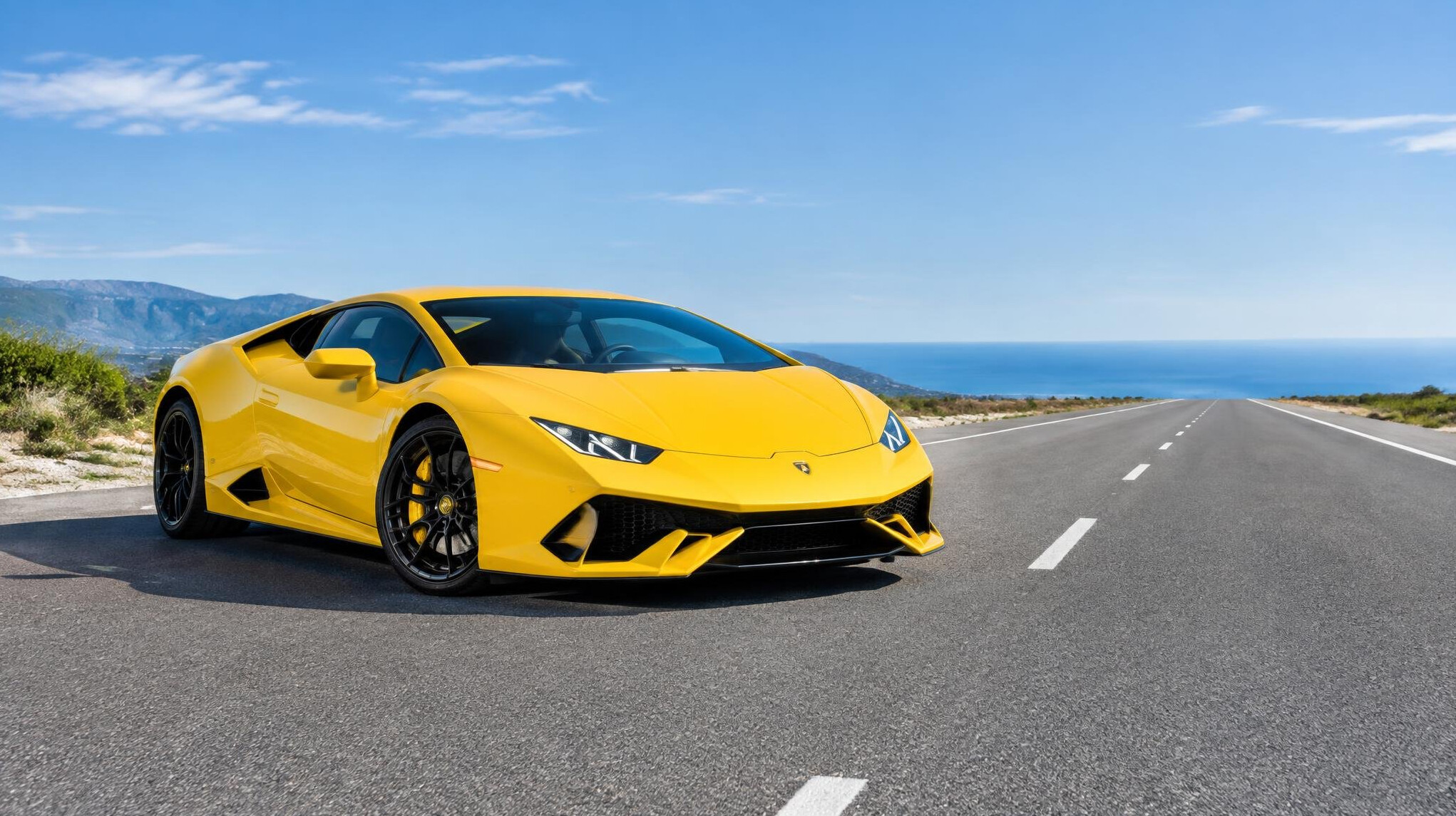 Yellow sports car on a wide road